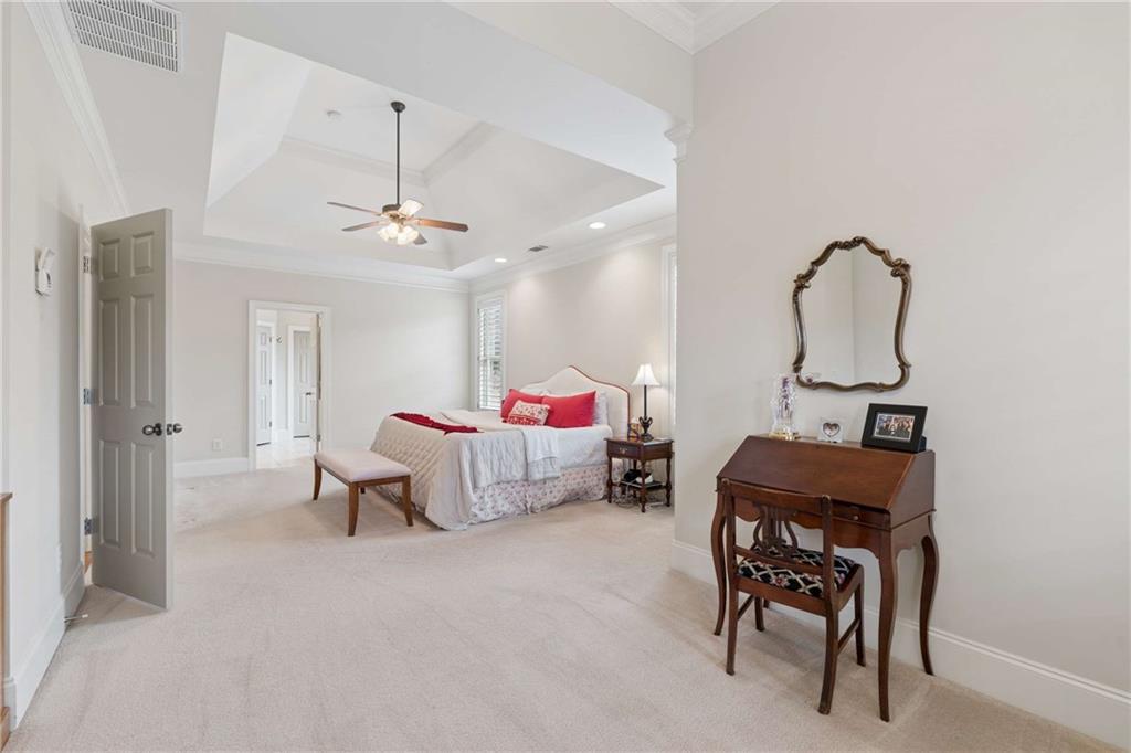 5148 Stefan Ridge Way Buford, GA 30519 - Photo 20 of 39 a bed room with furniture and a mirror