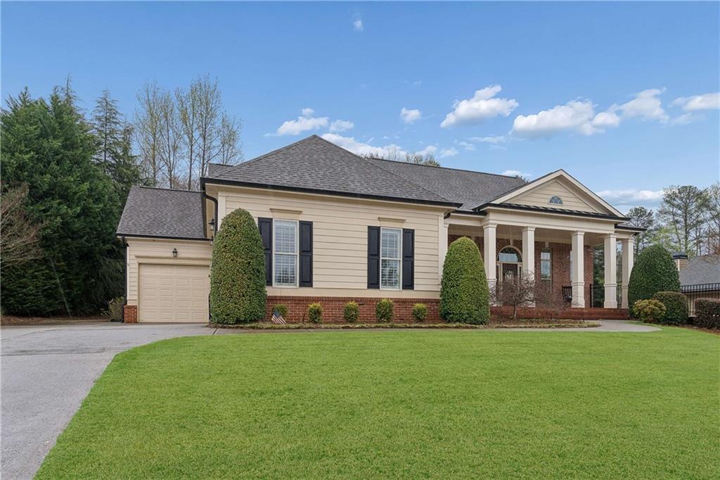 5148 Stefan Ridge Way Buford, GA 30519 - Photo 2 of 39 a front view of a house with a garden and plants