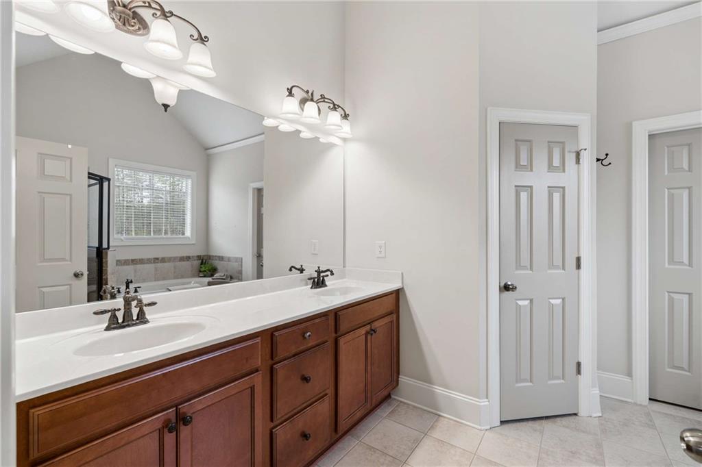 5148 Stefan Ridge Way Buford, GA 30519 - Photo 21 of 39 a bathroom with a double vanity sink a and mirror