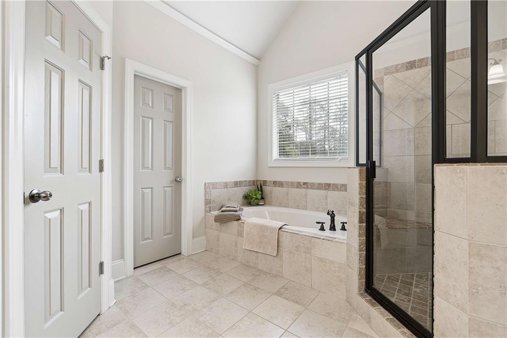 5148 Stefan Ridge Way Buford, GA 30519 - Photo 22 of 39 a spacious bathroom with a bathtub and a shower