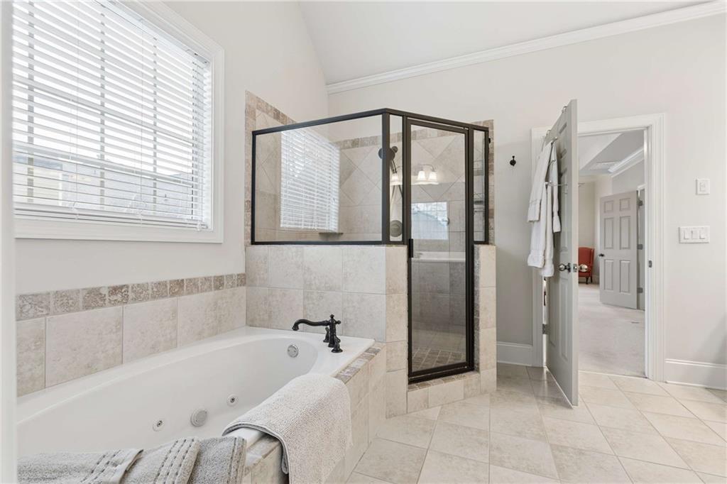 5148 Stefan Ridge Way Buford, GA 30519 - Photo 23 of 39 a bathroom with a bathtub and a shower