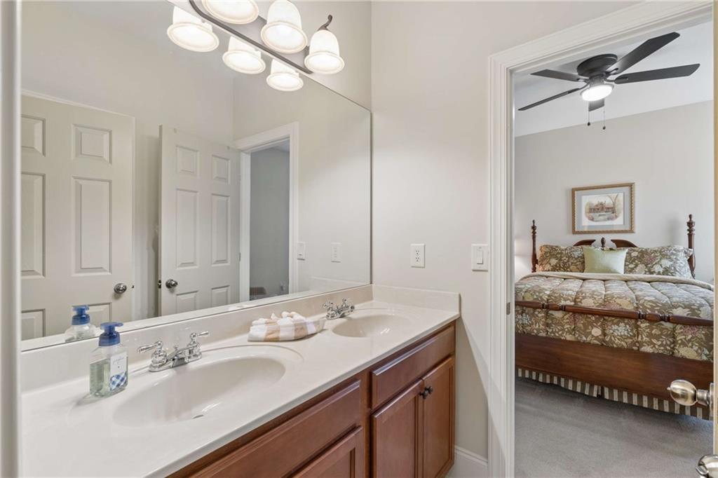 5148 Stefan Ridge Way Buford, GA 30519 - Photo 25 of 39 a en suite bathroom with a double vanity sink and a mirror