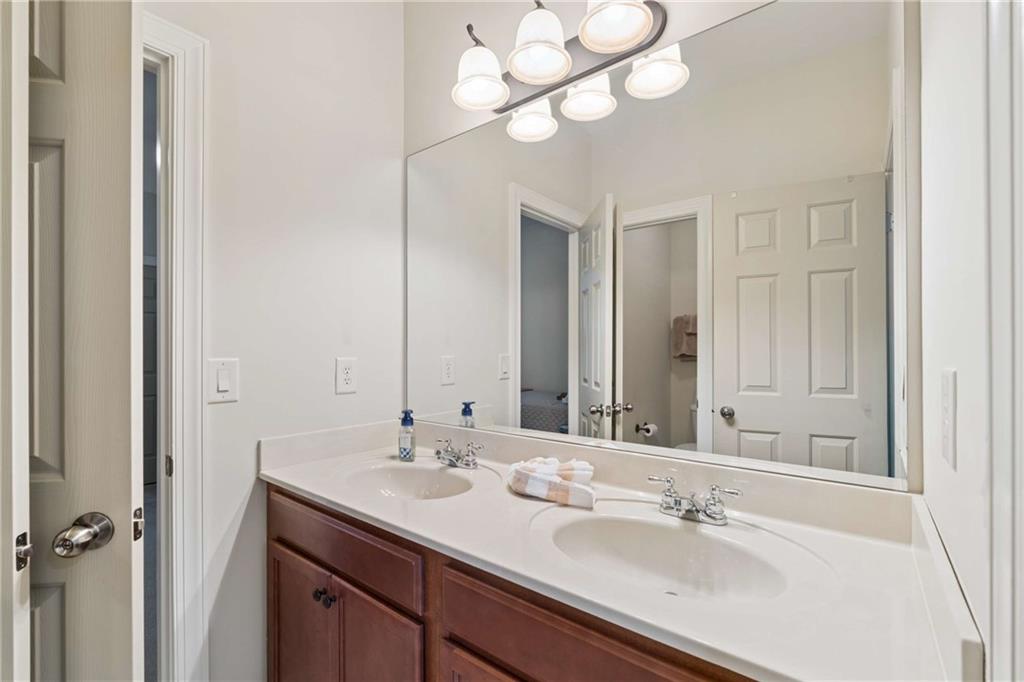5148 Stefan Ridge Way Buford, GA 30519 - Photo 27 of 39 a bathroom with a sink a light fixture and a mirror