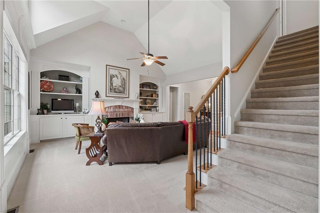 5148 Stefan Ridge Way Buford, GA 30519 - Photo 28 of 39 a living room with furniture fireplace and flat screen tv