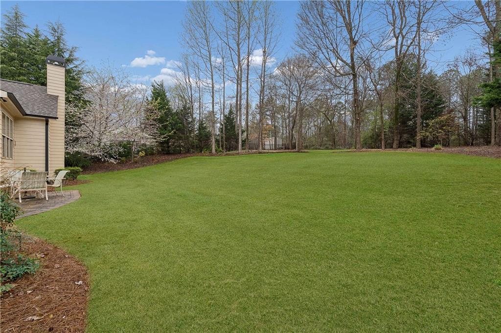 5148 Stefan Ridge Way Buford, GA 30519 - Photo 36 of 39 a view of a field of grass and trees