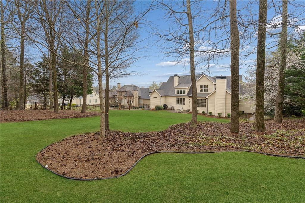 5148 Stefan Ridge Way Buford, GA 30519 - Photo 39 of 39 a view of a house with a backyard