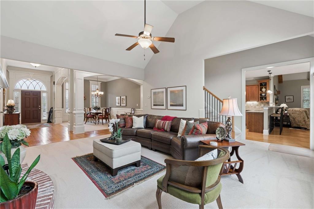 5148 Stefan Ridge Way Buford, GA 30519 - Photo 6 of 39 a living room with furniture and a chandelier