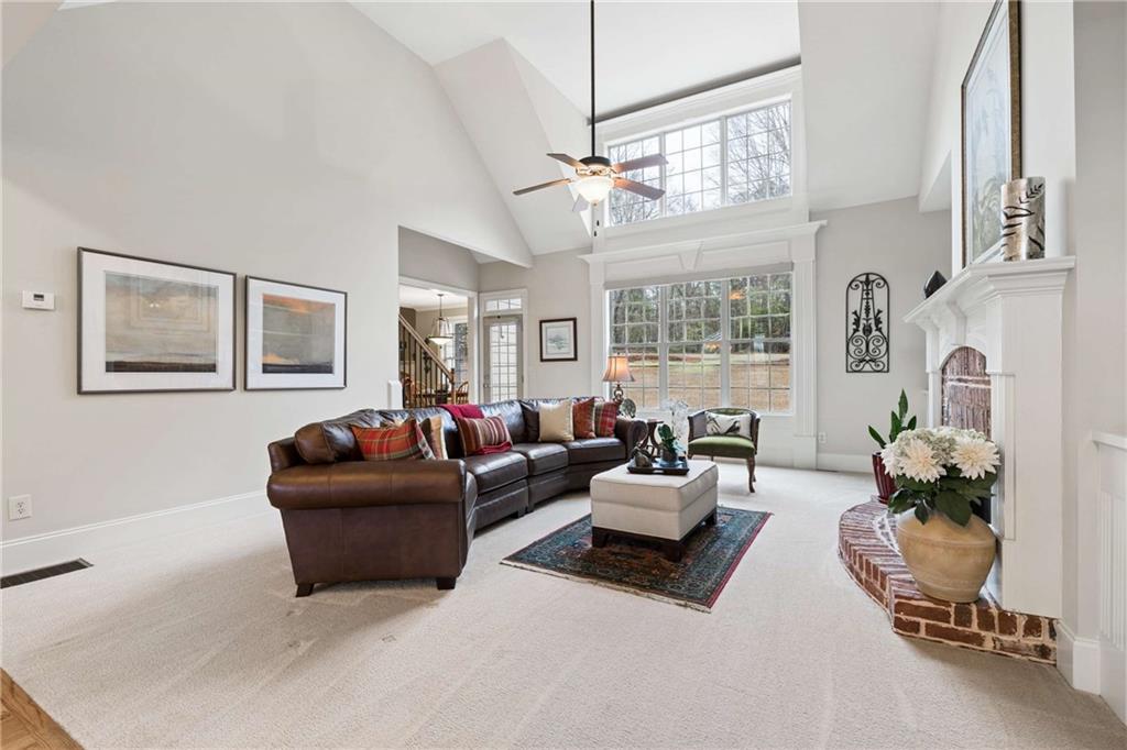 5148 Stefan Ridge Way Buford, GA 30519 - Photo 7 of 39 a living room with furniture chandelier and a window