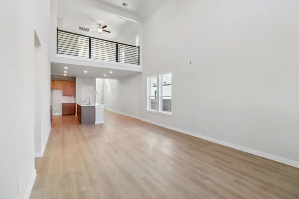 a view of livingroom and a kitchen with wooden floor