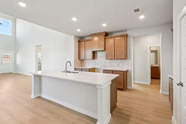 a large kitchen with stainless steel appliances granite countertop a sink and cabinets