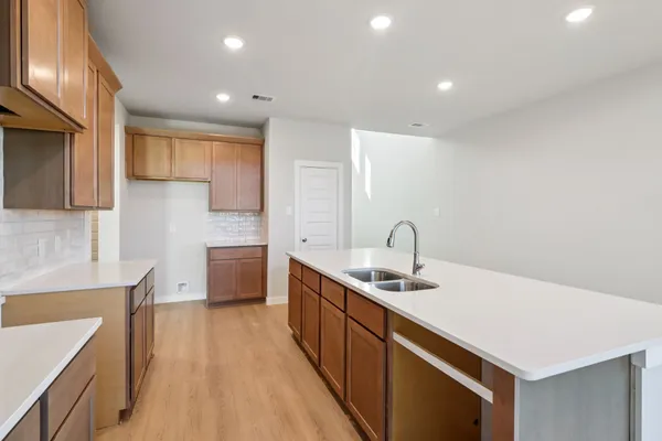 a kitchen with a sink stove and cabinets