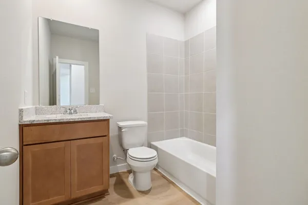 a bathroom with a toilet a sink and bathtub