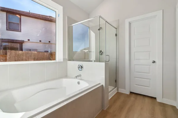 a bathroom with a bathtub and a shower