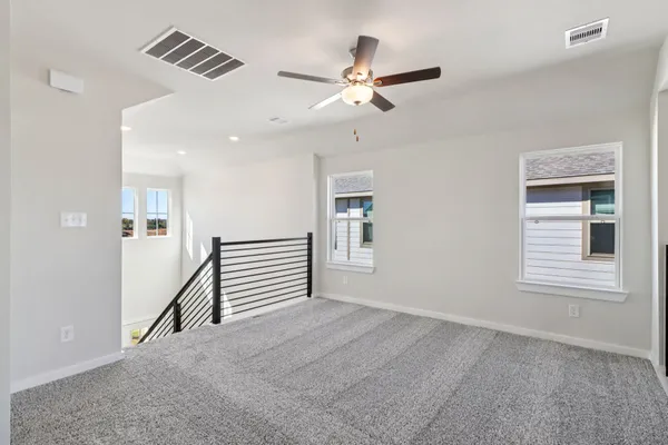 a view of a livingroom with a ceiling fan and window