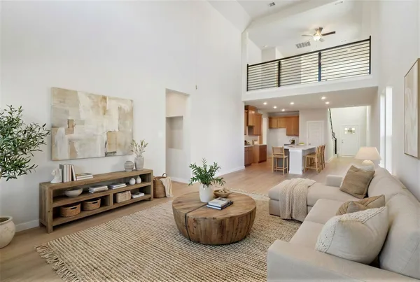 a living room with furniture and a potted plant