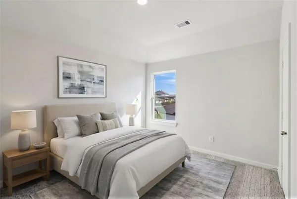 a bedroom with a bed and a painting on the wall