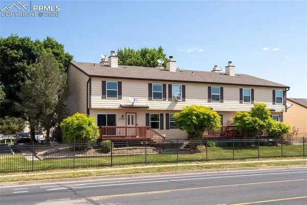 a front view of a house with swimming pool and glass windows
