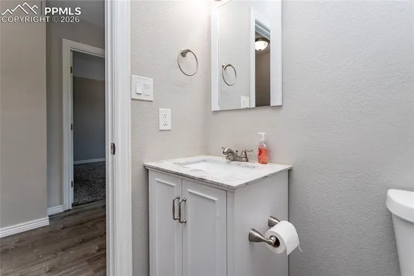 a bathroom with a sink and mirror with vanity