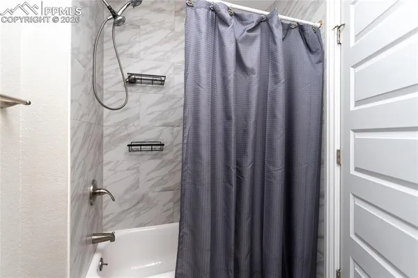 a bathroom with a glass shower door