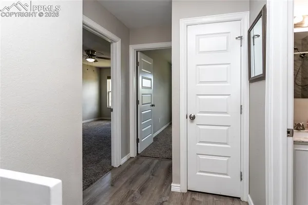 a view of a hallway with wooden floor
