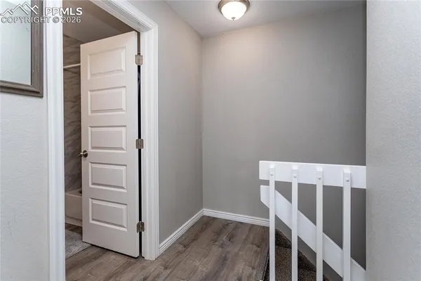a view of walk in closet with empty racks