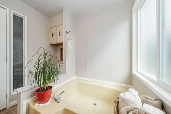 a bath tub sitting next to a window
