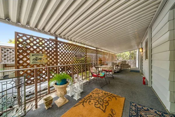 a view of a patio with table and chairs and potted plants