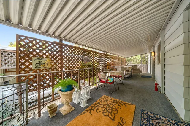 a view of a patio with table and chairs and potted plants