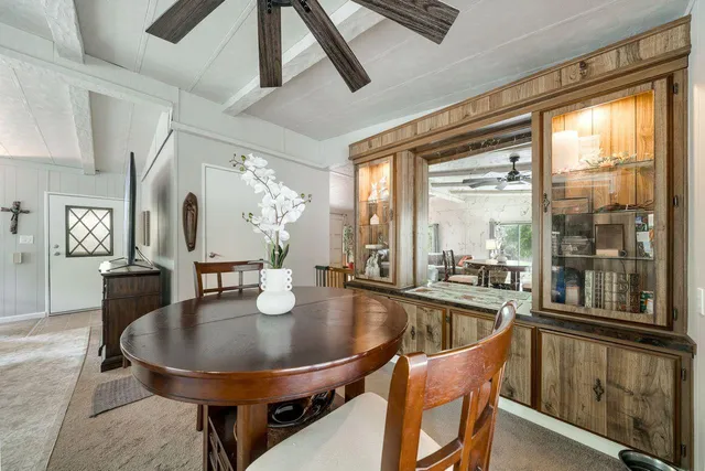 a dining room with furniture a chandelier and window