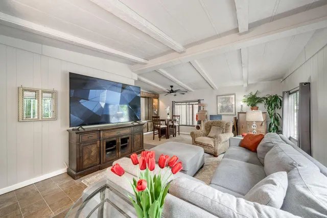 a living room with fireplace furniture and a flat screen tv