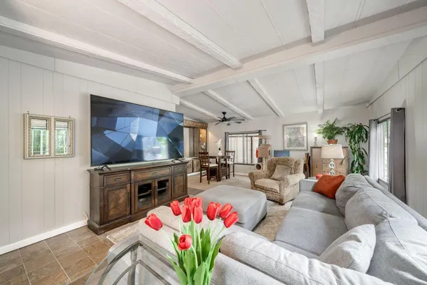 a living room with fireplace furniture and a flat screen tv