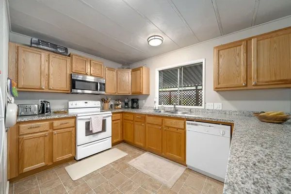 a kitchen with a sink stove top oven and cabinets