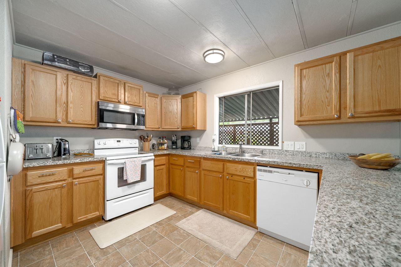 450 Gladycon Road, Unit 52 Colfax, CA 95713 - Photo 10 of 29 a kitchen with a sink stove top oven and cabinets