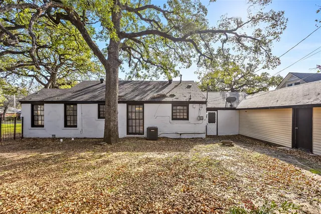 a house that has a tree in front of it