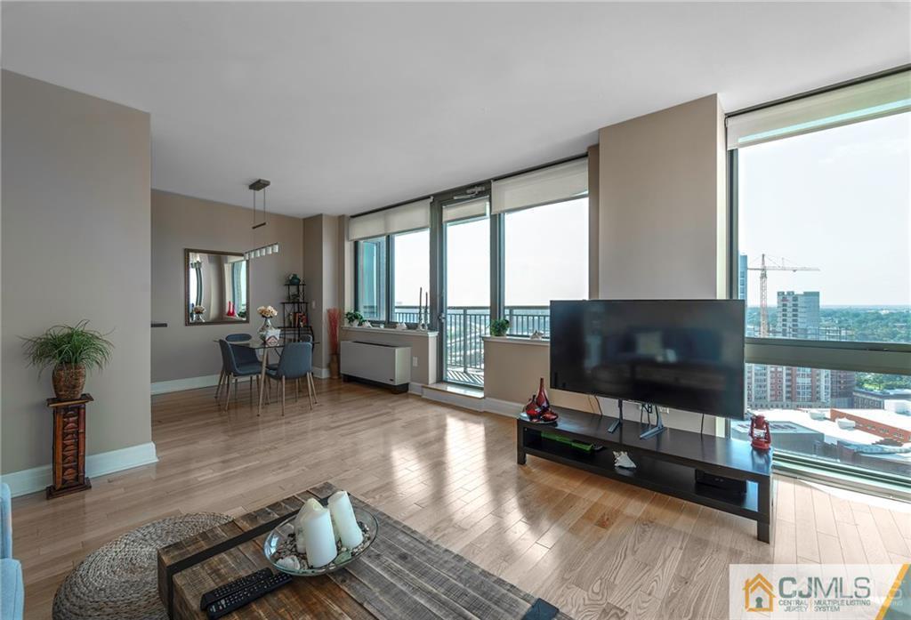 1 Spring Street, Unit 2204 New Brunswick, NJ 08901 - Photo 8 of 29 a living room with furniture and a flat screen tv