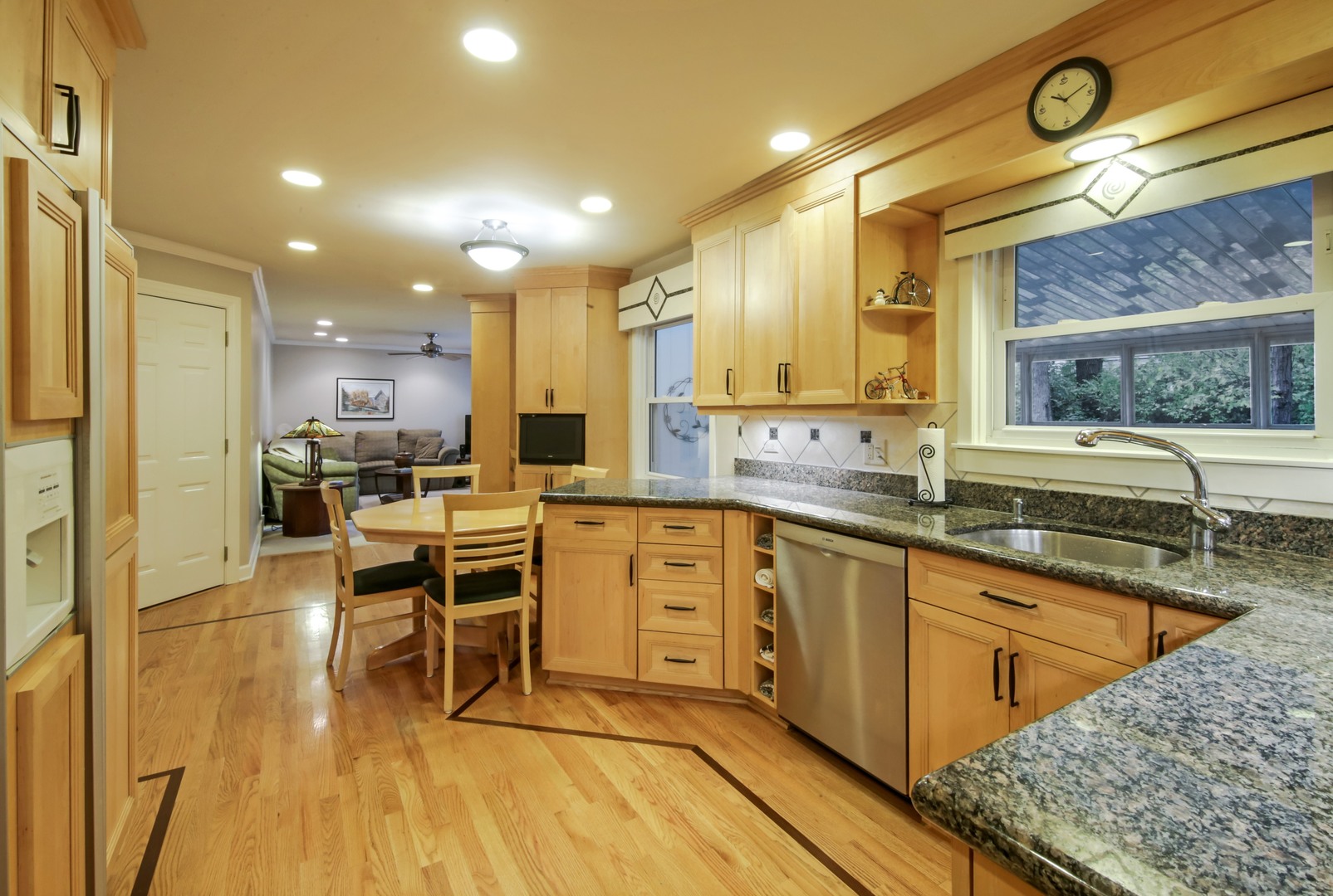1426 Kenton Road Deerfield, IL 60015 - Photo 4 of 15 a large kitchen with kitchen island a sink table and chairs