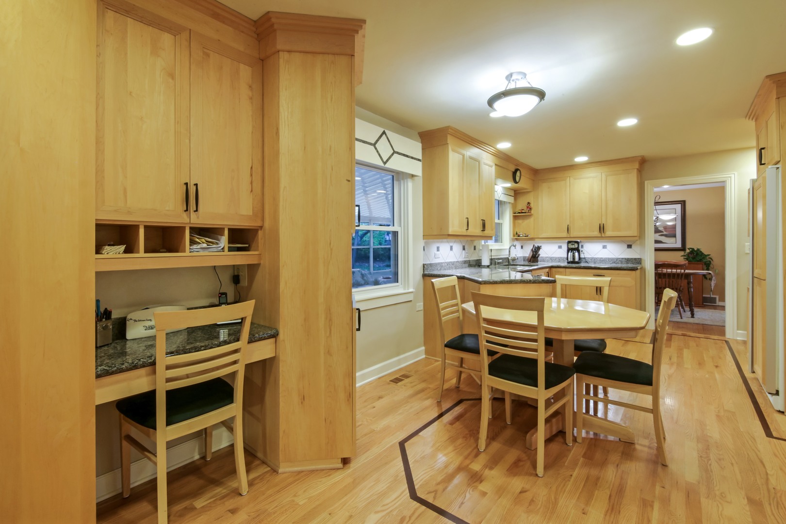 1426 Kenton Road Deerfield, IL 60015 - Photo 5 of 15 a dining room with stainless steel appliances kitchen island granite countertop a table and chairs