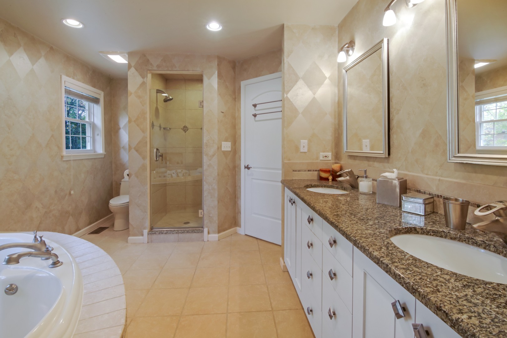 1426 Kenton Road Deerfield, IL 60015 - Photo 8 of 15 a spacious bathroom with a granite countertop sink mirror and shower