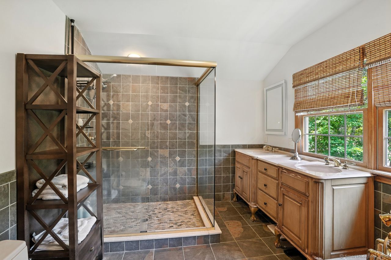 68 Old Dike Road Trumbull, CT 06611 - Photo 20 of 40 a bathroom with a granite countertop sink a toilet and shower
