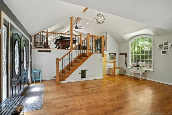 a view of entryway and hall with wooden floor