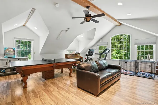 a living room with furniture and a wooden floor
