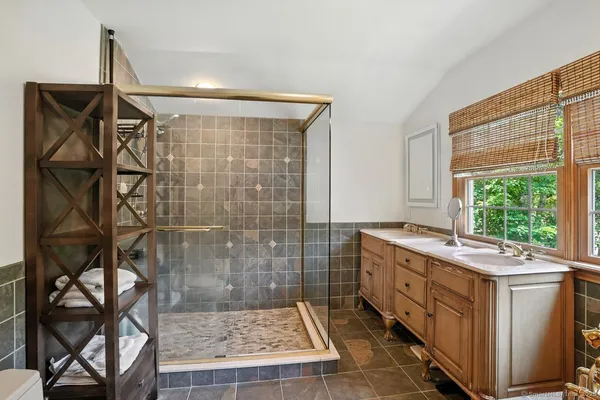 a bathroom with a granite countertop sink a toilet and shower