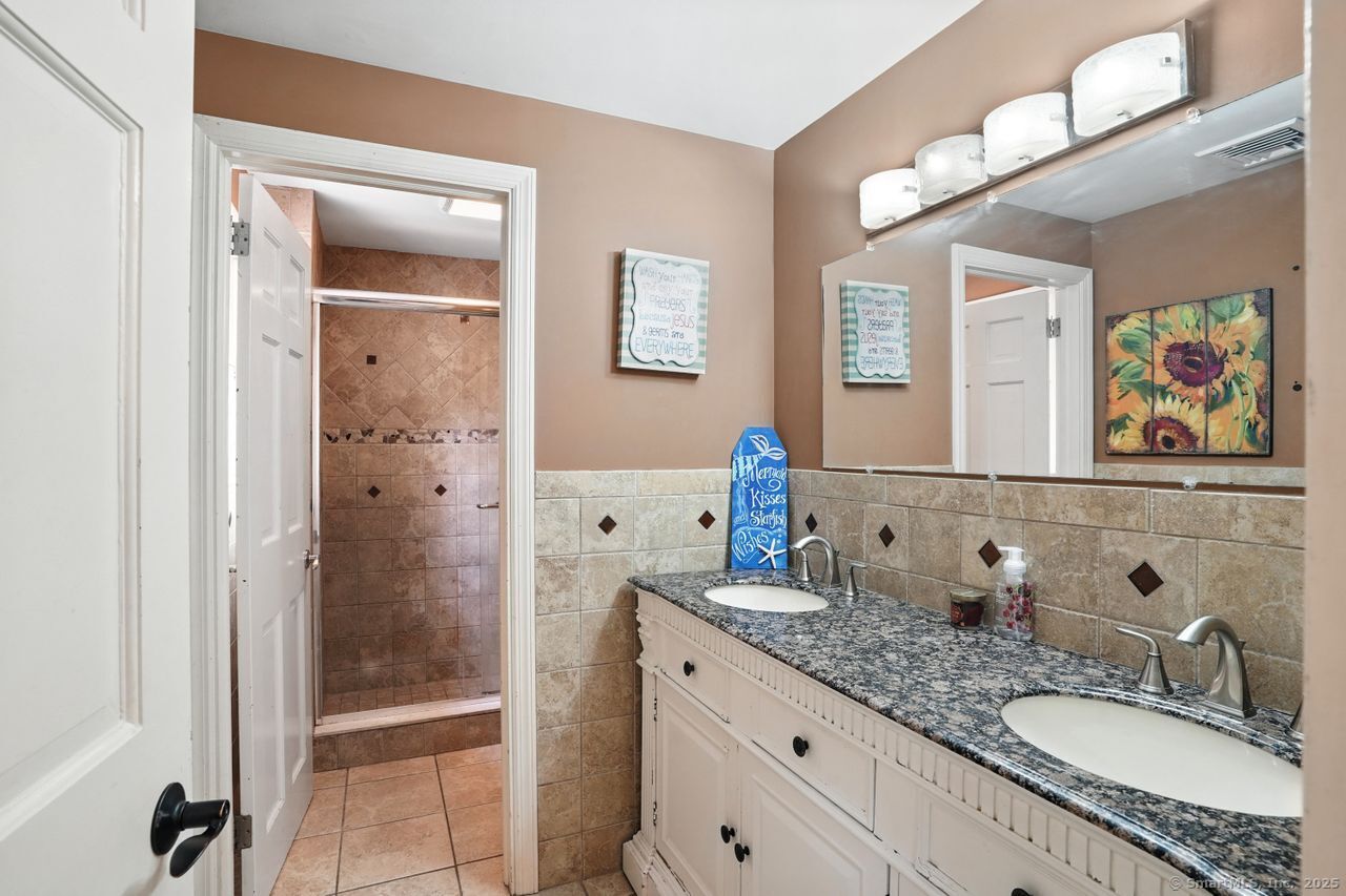 68 Old Dike Road Trumbull, CT 06611 - Photo 24 of 40 a bathroom with double sink and a mirror
