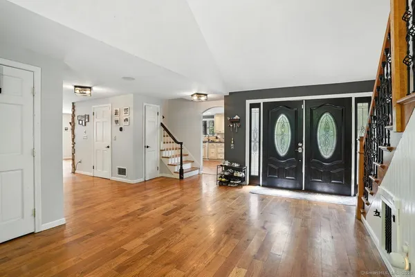 a view of an entryway with wooden floor