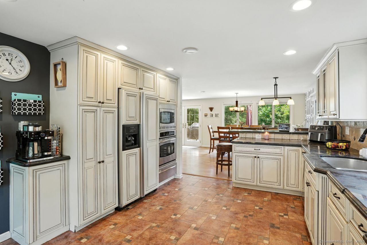 68 Old Dike Road Trumbull, CT 06611 - Photo 7 of 40 a kitchen with stainless steel appliances a refrigerator sink and stove
