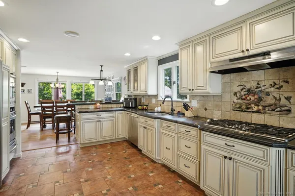 a kitchen with stainless steel appliances granite countertop a sink and cabinets