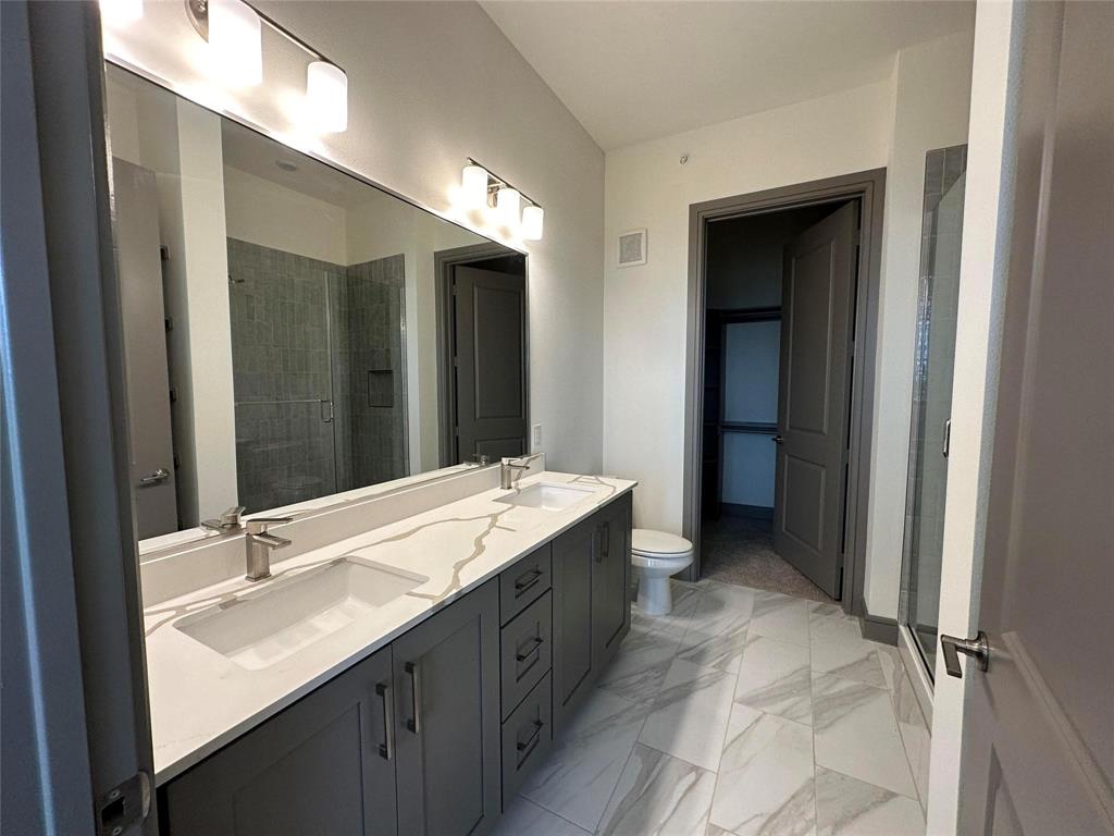 2700 Old Denton Road, Unit 4434 Carrollton, TX 75007 - Photo 11 of 13 a bathroom with a double vanity sink and a mirror