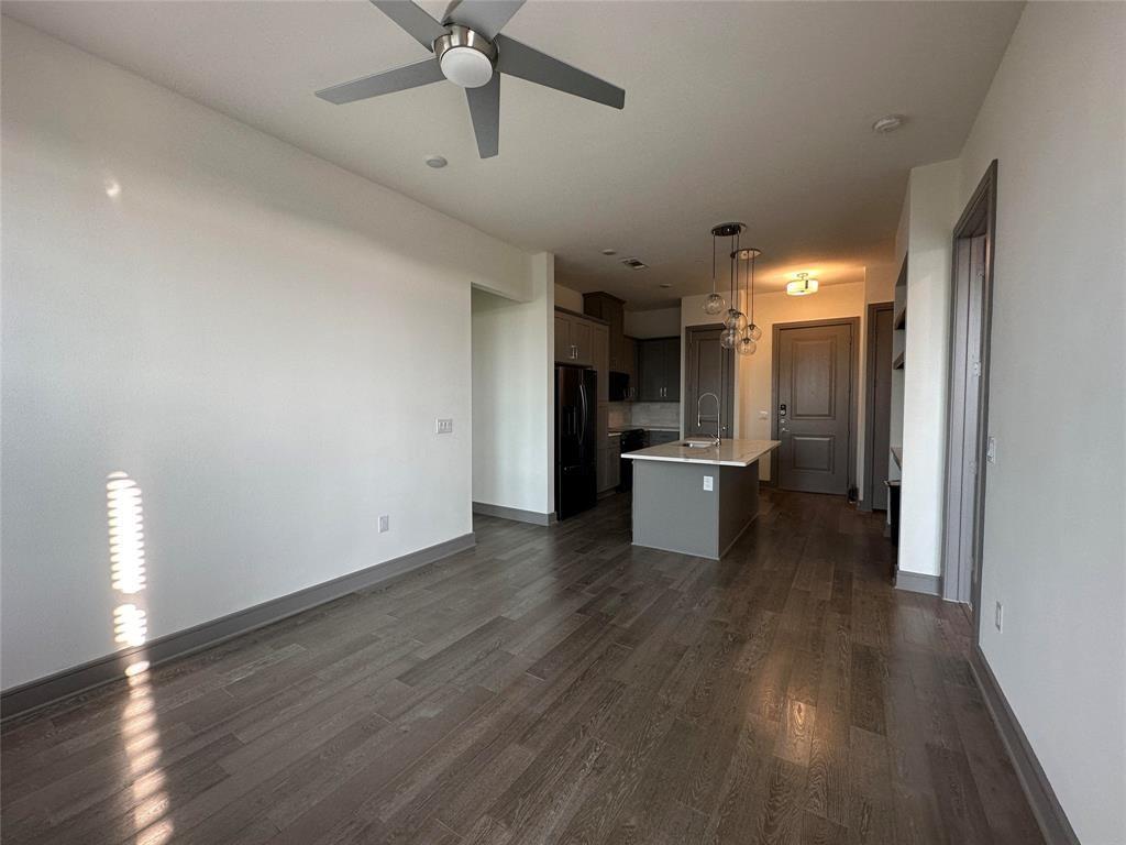 2700 Old Denton Road, Unit 4434 Carrollton, TX 75007 - Photo 6 of 13 a view of a kitchen with a sink and a refrigerator