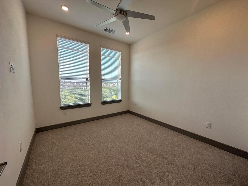 2700 Old Denton Road, Unit 4434 Carrollton, TX 75007 - Photo 7 of 13 an empty room with windows and ceiling fan