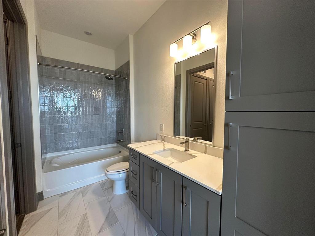 2700 Old Denton Road, Unit 4434 Carrollton, TX 75007 - Photo 9 of 13 a bathroom with a granite countertop sink toilet and shower